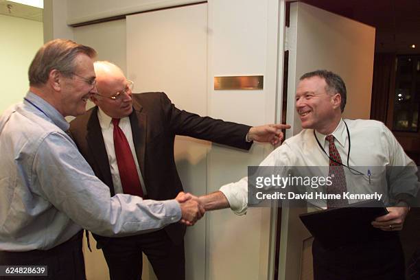 Secretary of Defense Donald Rumsfeld greets Scooter Libby and Vice President-elect Dick Cheney in December 2000 at the transition team headquarters...