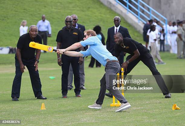 Prince Harry and cricketers Andy Roberts, Vivian Richards and Curtly Ambrose attend a youth sports festival at Sir Vivian Richards Stadium showcasing...