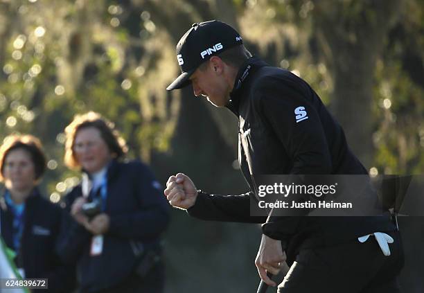 Mackenzie Hughes of Canada celebrates after putting on the 17th green during the playoff in the final round of the RSM Classic at Sea Island Resort...