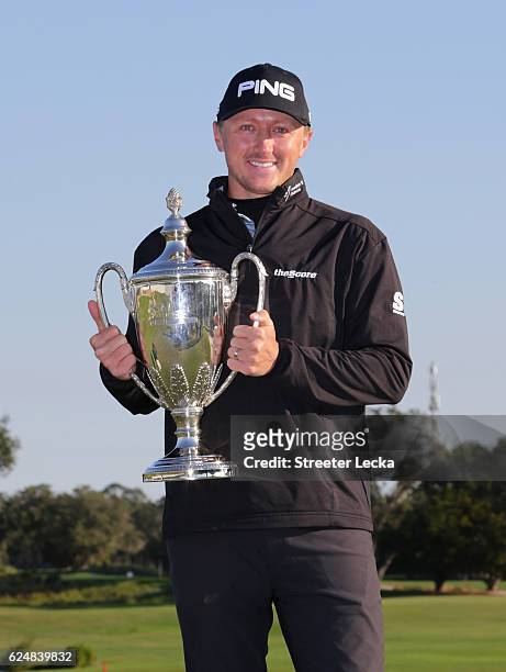 Mackenzie Hughes of Canada poses with his trophy after winning the playoff of the final round of the RSM Classic at Sea Island Resort Seaside Course...