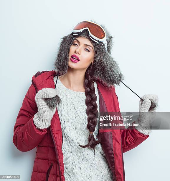 sensual woman in winter outfit - puffer jacket, fur hat - fur glove stock pictures, royalty-free photos & images