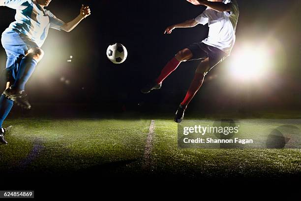 two soccer players fighting for the ball - championship round two foto e immagini stock