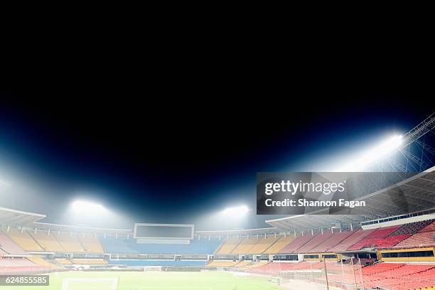 view of empty stadium with lights at night - サッカー場　無人 ストックフォトと画像