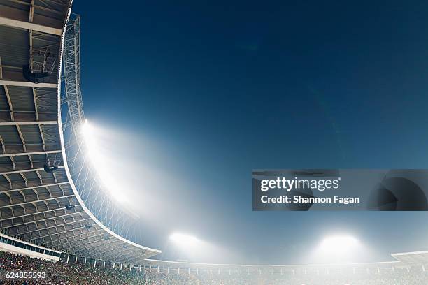 bright stadium lights against a dusk sky - stadium fotografías e imágenes de stock