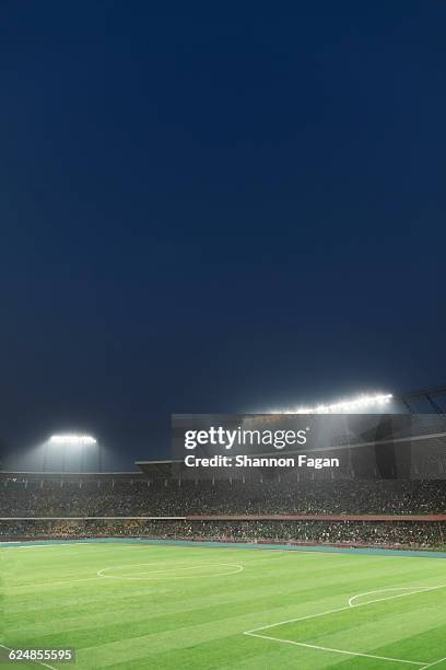 stadium lights and crowd at soccer field - china football stock pictures, royalty-free photos & images