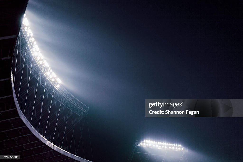 Stadium lights glowing against night sky