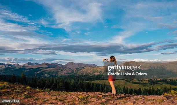 girl photographing landscape with smart phone - co op stock pictures, royalty-free photos & images