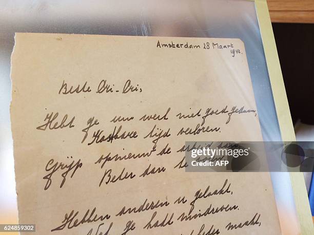 This photo taken on November 21, 2016 at the Bubb Kuyper auction house in Haarlem shows a rare handwritten poem by Anne Frank, penned shortly before...