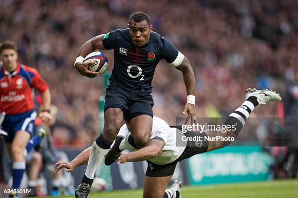 Semesa Rokoduguni of England runs in to score a try beyond the diving tackle of Metuisela Tabebula of Fiji during Old Mutual Wealth Series between...