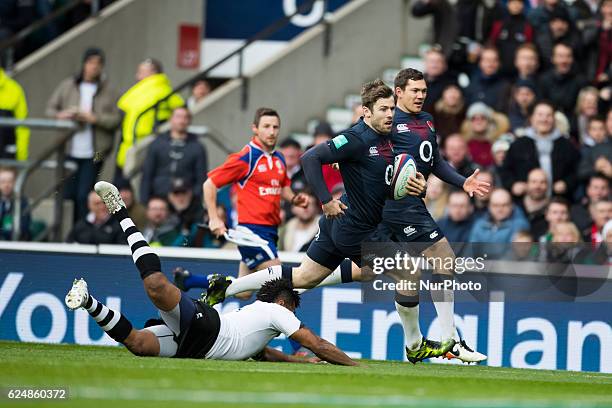Elliot Daly of England runs past the diving tackle of Metuisela Tabebula of Fiji during Old Mutual Wealth Series between England and Fiji played at...