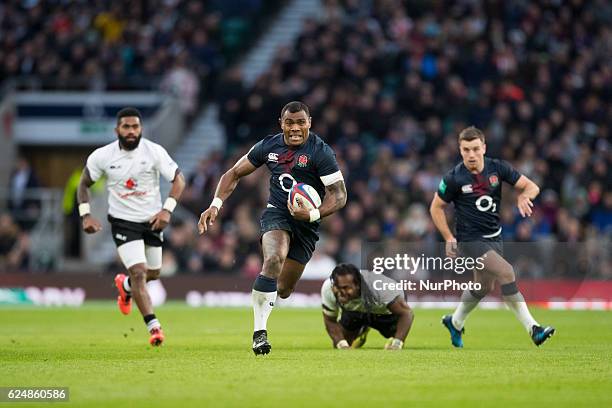 Semesa Rokoduguni of England runs free as both sets of players look on during Old Mutual Wealth Series between England and Fiji played at Twickenham...