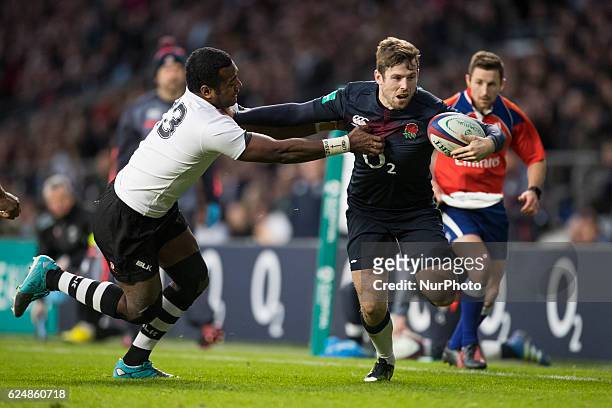 Elliot Daly of England breaks free from Kini Murimurivalu of Fiji uring Old Mutual Wealth Series between England and Fiji played at Twickenham...