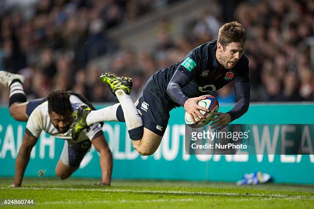 Elliot Daly of England dives for the line but is pushed into touch by a diving Metuisela Tabebula of Fiji during Old Mutual Wealth Series between...