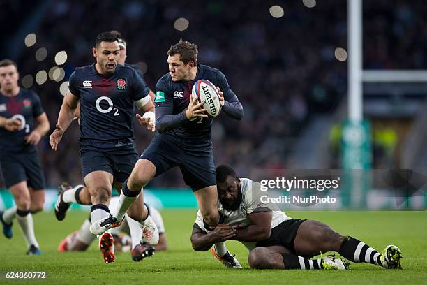 Alex Goode of England looks for a pass as Metuisela Tabebula of Fiji holds on from a tackle during Old Mutual Wealth Series between England and Fiji...