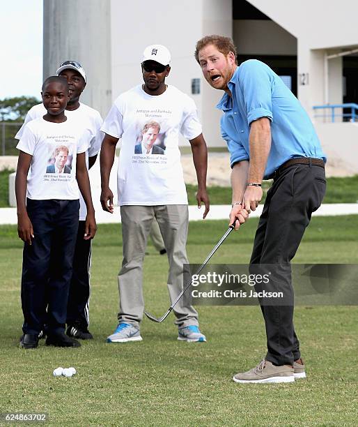 Prince Harry plays golf as he attends a youth sports festival at Sir Vivian Richards Stadium showcasing Antigua and Barbuda's national sports, on the...