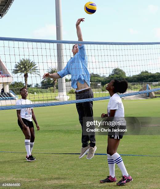 Prince Harry plays volleyball as he attends a youth sports festival at Sir Vivian Richards Stadium showcasing Antigua and Barbuda's national sports,...