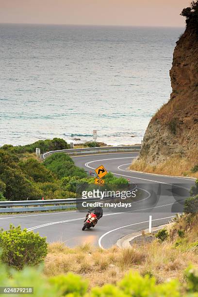 a motorbike rider next to the ocean, great ocean road, victoria, australia, south pacific - great ocean road stock pictures, royalty-free photos & images