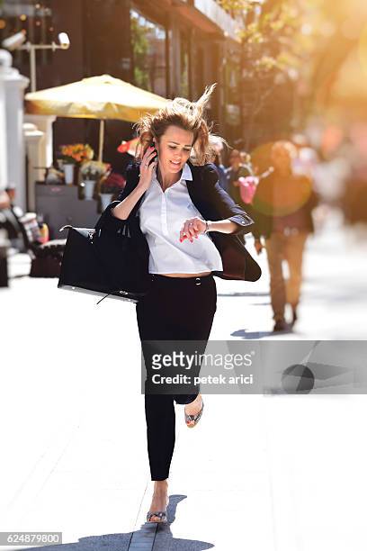 business woman rushing to work - time phone stock pictures, royalty-free photos & images