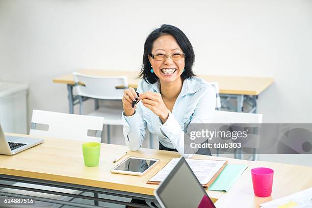 mature female teacher at a community college - student visa stockfoto's en -beelden