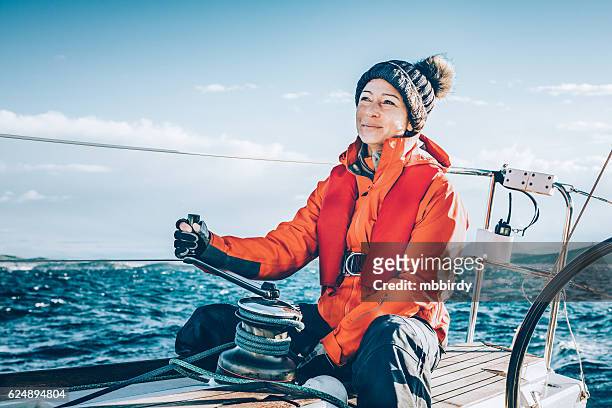 happy woman sailing during regatta - zeil stockfoto's en -beelden