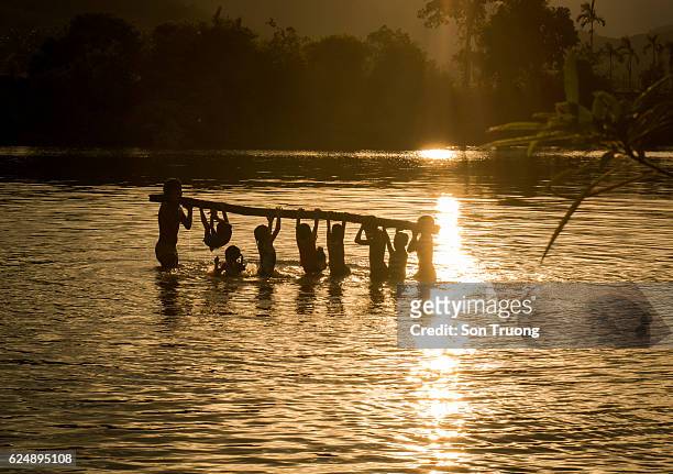the children bath river - vietnam war photos stock-fotos und bilder