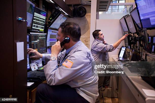 Traders work on the floor of the New York Stock Exchange in New York, U.S., on Monday, Nov. 21, 2016. U.S. Stocks were set for the highest closing...