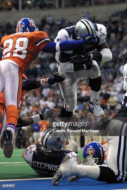 Running back Troy Hambrick of the Dallas Cowboys leaps in for a touchdown past Kenoy Kennedy of the Denver Broncos during the second half at Texas...