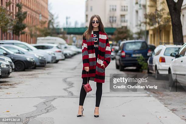 Jennifer Amanda wearing a red striped Gabrie oversized coat from Isabel Marant Etoile, a black rainbow logo sweater from Isabel Marant Etoile, "So...