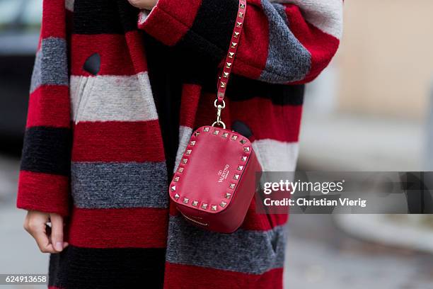 Jennifer Amanda wearing a red striped Gabrie oversized coat from Isabel Marant Etoile, a black rainbow logo sweater from Isabel Marant Etoile, "So...