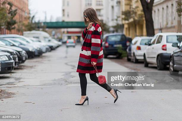 Jennifer Amanda wearing a red striped Gabrie oversized coat from Isabel Marant Etoile, a black rainbow logo sweater from Isabel Marant Etoile, "So...