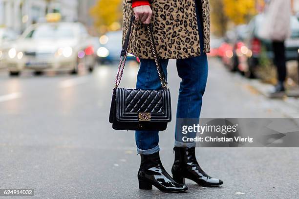 Nadine Bauer wearing a Mango coat with leo print, American Apparel denim jeans, blach Chanel bag, black Topshop boots on November 21, 2016 in Berlin,...