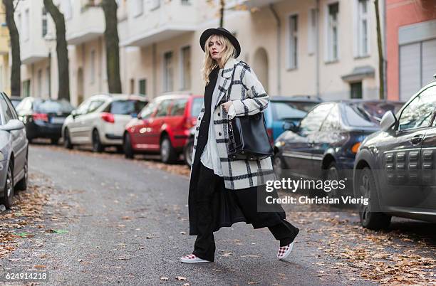 Marie Jaster wearing a black white checked plaid edited wool coat, and blouse, black h&m vest, a black utzon leather pants, red white checked vans...