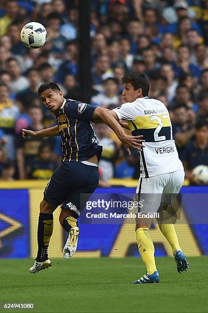 Teofilo Gutierrez of Rosario Central fights for the ball with Santiago Vergini of Boca Juniors during a match between Boca Juniors and Rosario...