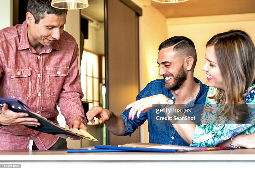 Sales Clerk Showing Fabric Swatches