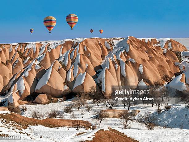 hot air ballooning at winter in cappadocia,turkey - cappadocia hot air balloon stock-fotos und bilder