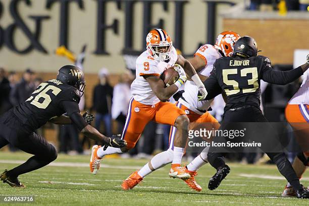 Clemson running back Wayne Gallman runs the ball while Wake Forest defensive end Duke Ejiofor and defensive back Thomas Brown attempt the tackle...