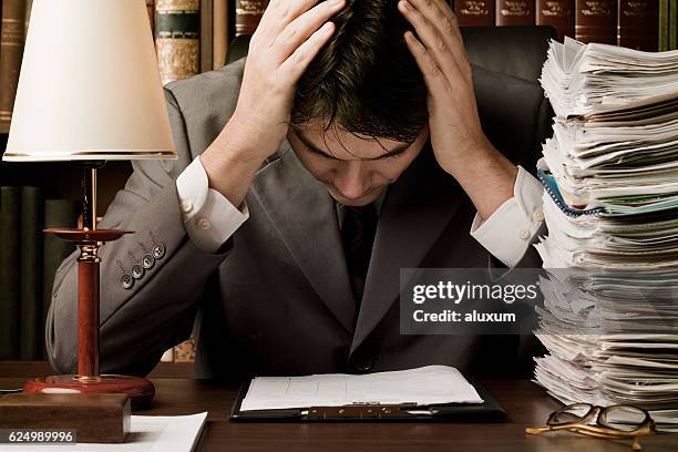man in suit stressed by work - legal problems stock pictures, royalty-free photos & images