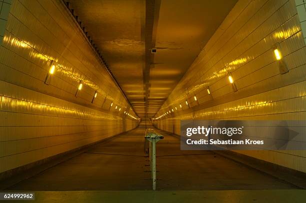 inside the bicycle tunnel of the masstunnel in rotterdam, the netherlands - meuse river stock pictures, royalty-free photos & images