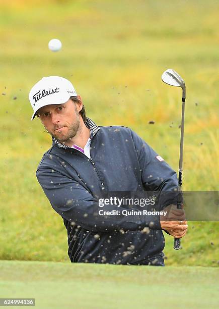 Martin Wiegele of Austria plays out of the bunker during a practise round ahead of the 2016 World Cup of Golf at Kingston Heath Golf Club on November...