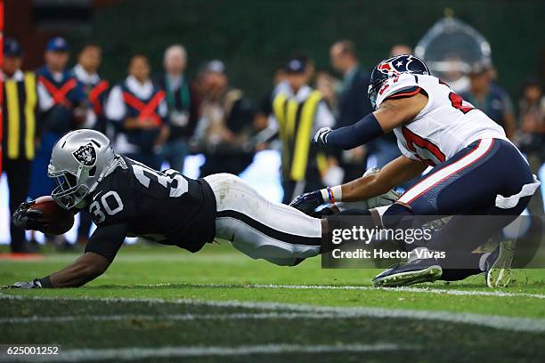 Jalen Richard of Oakland Raiders scores a touchdown against Quintin Demps of Houston Texans during the NFL football game between Houston Texans and...