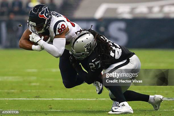 Reggie Nelson of Oakland Raiders tackles Stephen Anderson of Houston Texans during the NFL football game between Houston Texans and Oakland Raiders...