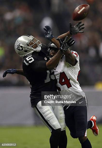 Johnathan Joseph of the Houston Texans breaks up a pass to Michael Crabtree of the Oakland Raiders in their game at Estadio Azteca on November 21,...