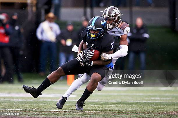 Sam Beal of the Western Michigan Broncos tackles Marcus McGill of the Buffalo Bulls in the first quarter at Waldo Field on November 19, 2016 in...