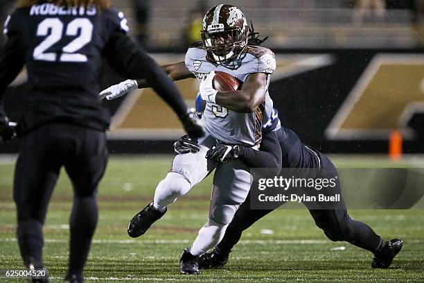 Matt Otwinowski of the Buffalo Bulls tackles Fabian Johnson of the Western Michigan Broncos in the fourth quarter at Waldo Field on November 19, 2016...