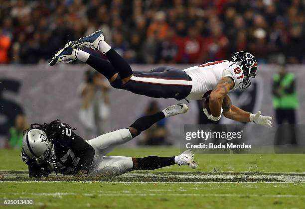 Fiedorowicz of the Houston Texans is tackled by Reggie Nelson of the Oakland Raiders in their game at Estadio Azteca on November 21, 2016 in Mexico...