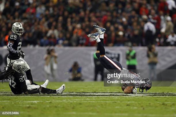 Fiedorowicz of the Houston Texans fumbles the ball after a hard hit by Reggie Nelson of the Oakland Raiders in their game at Estadio Azteca on...