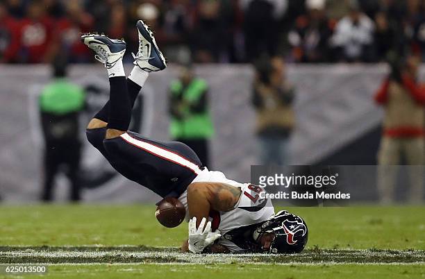 Fiedorowicz of the Houston Texans fumbles the ball after a hard hit by Reggie Nelson of the Oakland Raiders in their game at Estadio Azteca on...