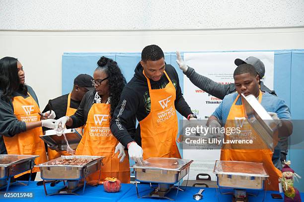 Nina Westbrook, Shannon Westbrook, Russell Westbrook, and Ray Westbrook serve Thanksgiving dinner at Russell Westbrook and Why Not? Foundation Host...