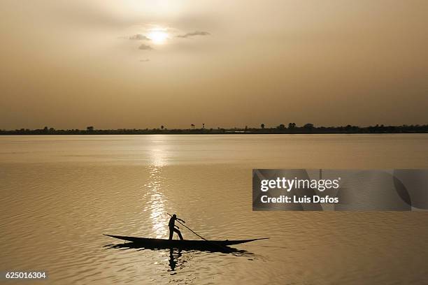 boat on niger river at sunset - dugout canoe ストックフォトと画像