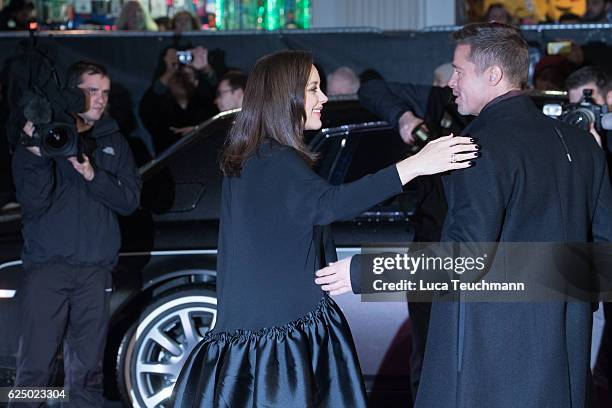 Marion Cotillard and Brad Pitt attend the UK Premiere of "Allied" at Odeon Leicester Square on November 21, 2016 in London, England.